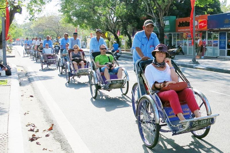 Traveling by cyclo to Perfume River